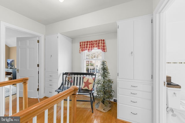 interior space featuring light wood-style floors and an upstairs landing