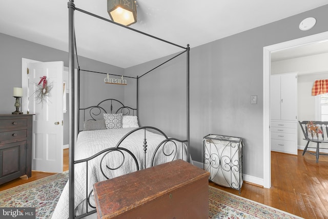 bedroom featuring wood finished floors and baseboards