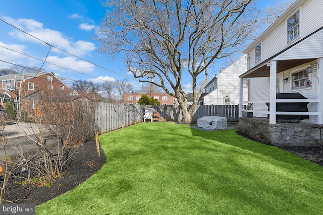 view of yard featuring a fenced backyard and a residential view