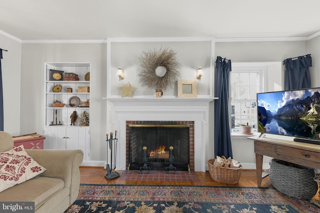 living area featuring a fireplace, baseboards, and crown molding