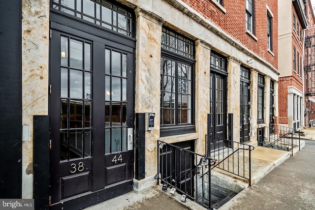 doorway to property featuring brick siding