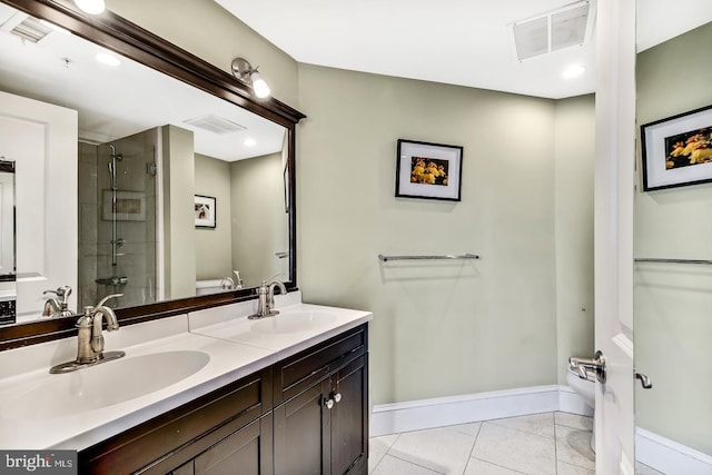 bathroom featuring toilet, a shower stall, visible vents, and a sink