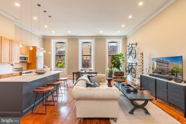 living room with recessed lighting, hardwood / wood-style flooring, and crown molding