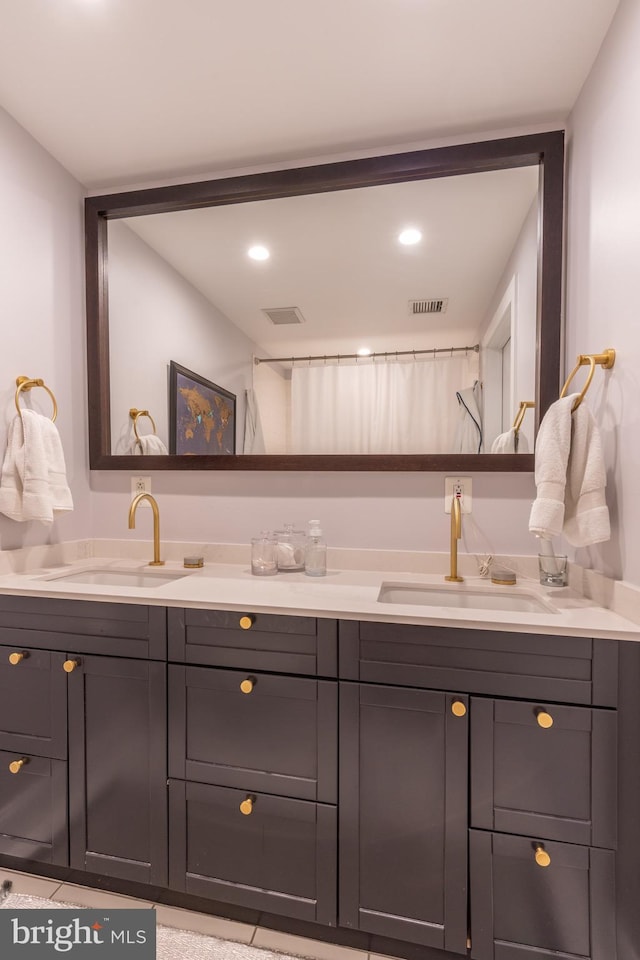 full bathroom featuring visible vents, a sink, and double vanity