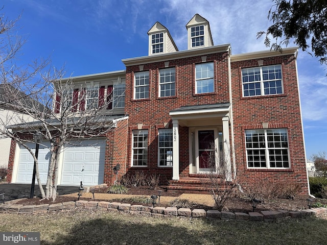 colonial-style house with aphalt driveway and brick siding