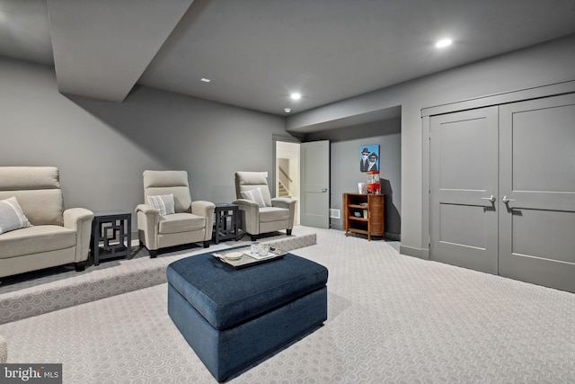 sitting room with recessed lighting, light colored carpet, and baseboards