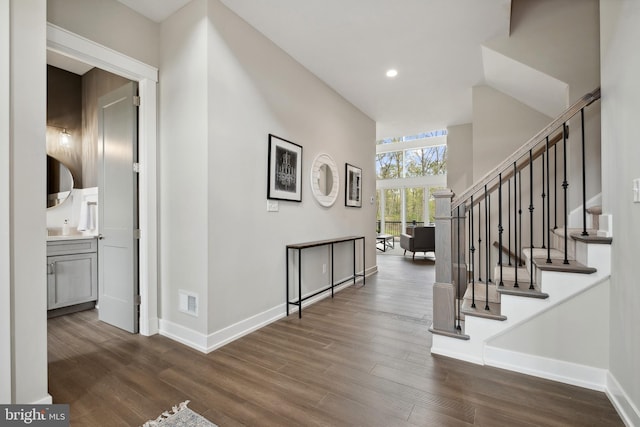 entryway featuring recessed lighting, visible vents, baseboards, stairs, and dark wood finished floors