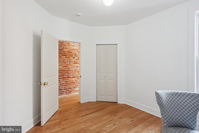 living area featuring light wood-style floors and baseboards