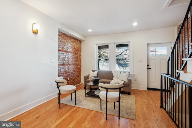 sitting room featuring stairs, recessed lighting, wood finished floors, and baseboards