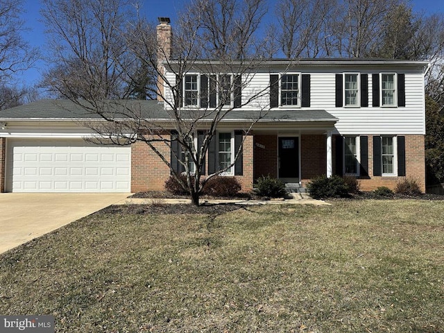 view of front of property featuring brick siding, a front lawn, concrete driveway, a chimney, and an attached garage