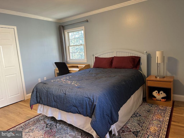 bedroom with ornamental molding, baseboards, and light wood finished floors