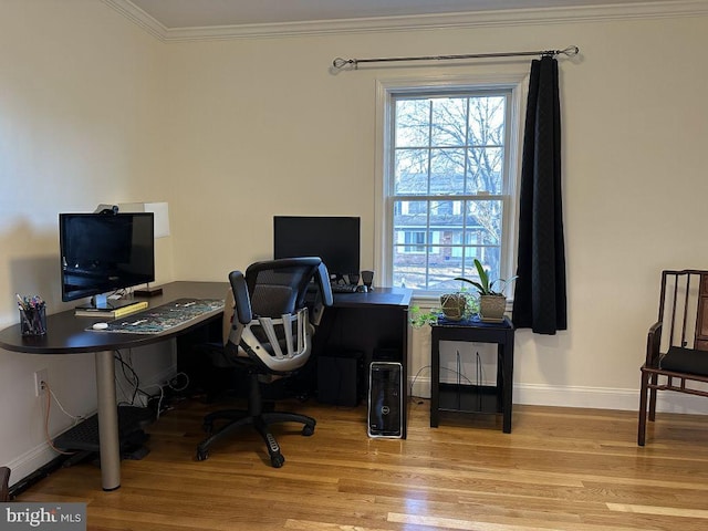 home office featuring baseboards, light wood finished floors, and crown molding