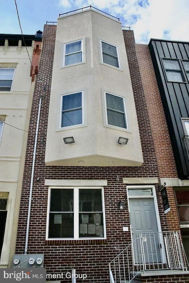 multi unit property with brick siding and stucco siding