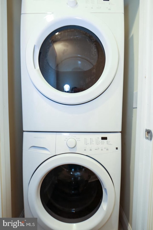 laundry area featuring stacked washer and clothes dryer