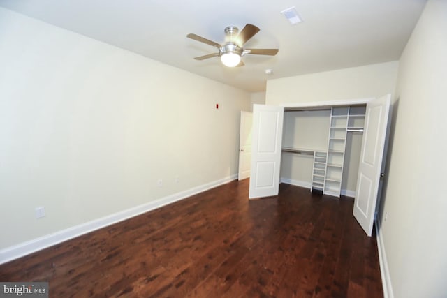 unfurnished bedroom featuring a closet, wood finished floors, a ceiling fan, and baseboards