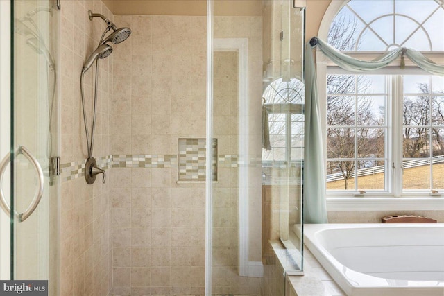 bathroom with a bath and a shower stall