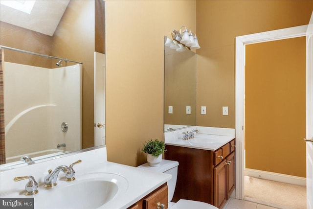 full bathroom featuring vanity, a skylight, shower / bath combination, tile patterned floors, and toilet