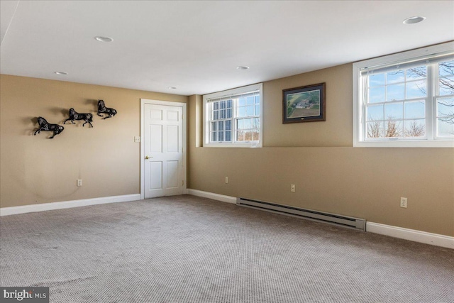 carpeted spare room with recessed lighting, a baseboard heating unit, and baseboards