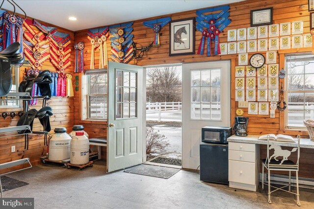 interior space featuring tile patterned floors, wood walls, and a baseboard radiator