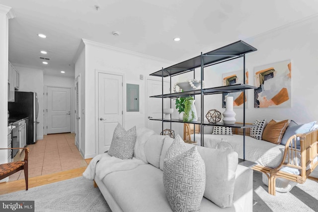 living area with visible vents, ornamental molding, electric panel, and recessed lighting