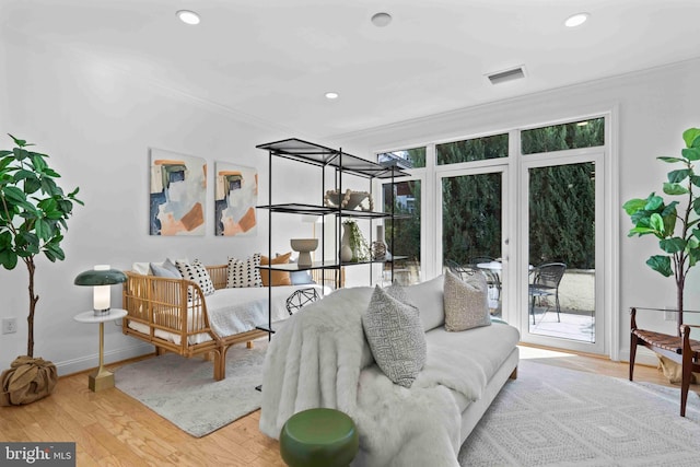 interior space with visible vents, crown molding, baseboards, and wood finished floors