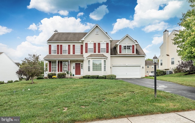 view of front of property featuring aphalt driveway, covered porch, a front lawn, and a garage