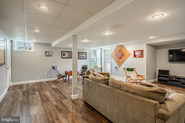 living area with dark wood-style floors, baseboards, a drop ceiling, and recessed lighting