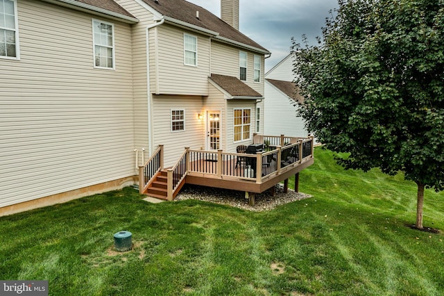 back of house with a yard and a wooden deck