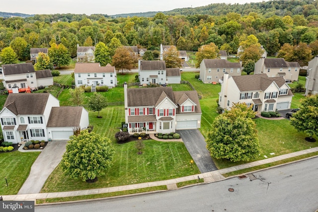 aerial view featuring a forest view and a residential view