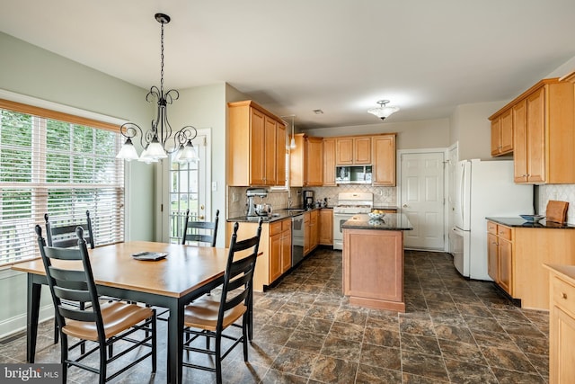 kitchen with white appliances, backsplash, a kitchen island, and decorative light fixtures