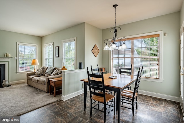 dining space with plenty of natural light, baseboards, and stone finish flooring