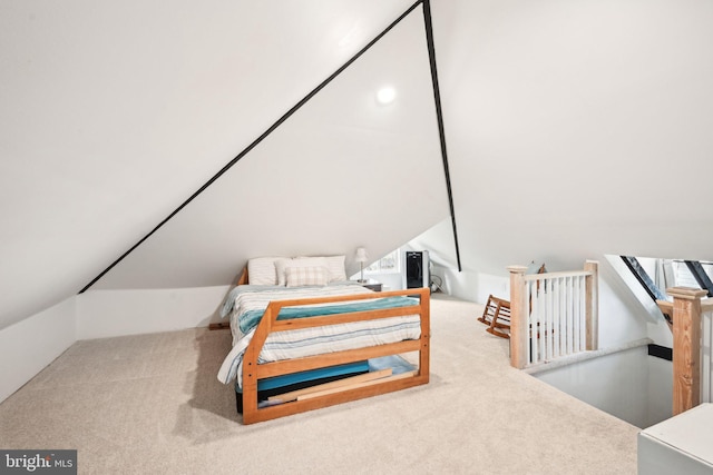 bedroom with lofted ceiling and carpet