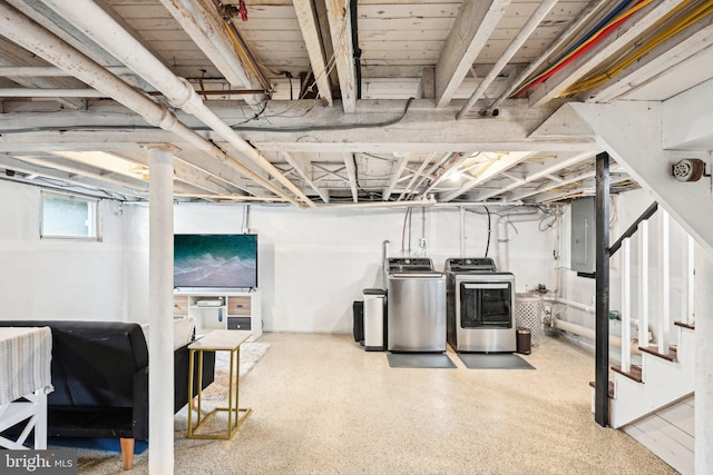 below grade area featuring stairway, washing machine and clothes dryer, and electric panel