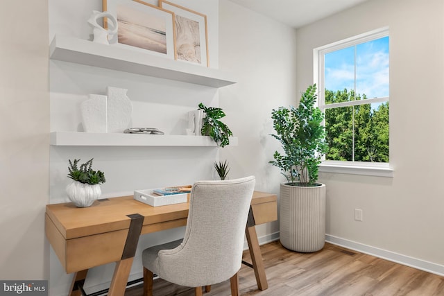 office space featuring light wood finished floors and baseboards