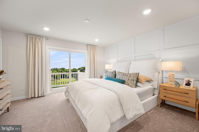 bedroom with recessed lighting, a decorative wall, light carpet, access to outside, and baseboards