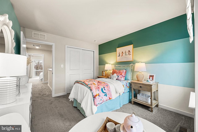 bedroom featuring carpet, a closet, visible vents, and baseboards