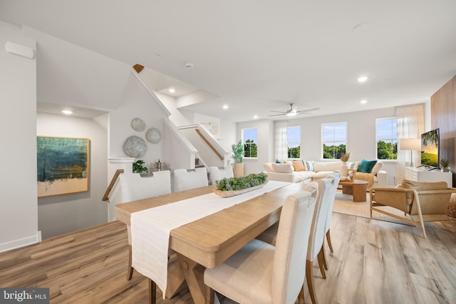 dining room featuring light wood-type flooring, stairs, a ceiling fan, and recessed lighting