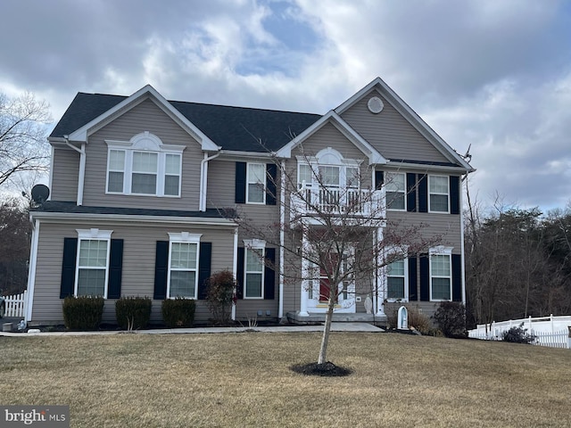 view of front of property with a front yard and fence