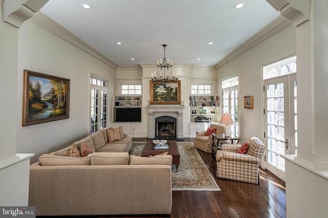 living area with a fireplace, dark wood finished floors, a notable chandelier, and recessed lighting