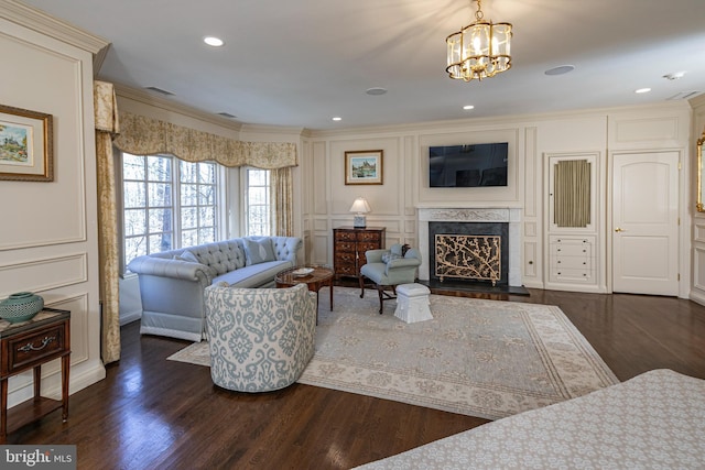 living area featuring a premium fireplace, dark wood finished floors, visible vents, and a decorative wall