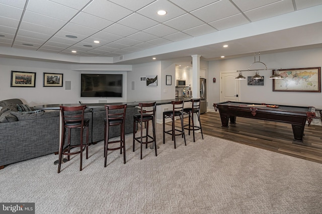 bar with recessed lighting, stainless steel microwave, a dry bar, and wood finished floors