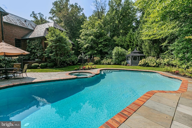 view of pool featuring a gazebo, a patio, and a pool with connected hot tub