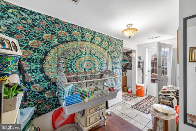 interior space featuring light tile patterned floors and visible vents
