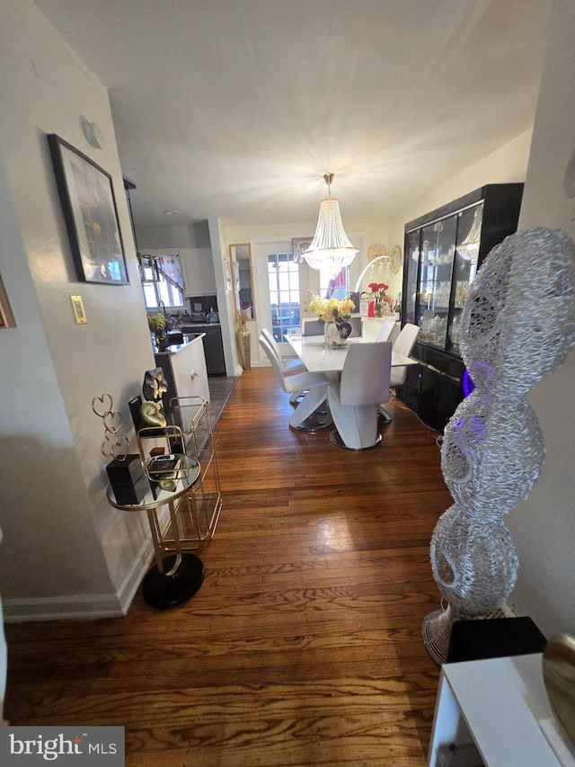 dining room with dark wood-style floors, a wealth of natural light, and baseboards