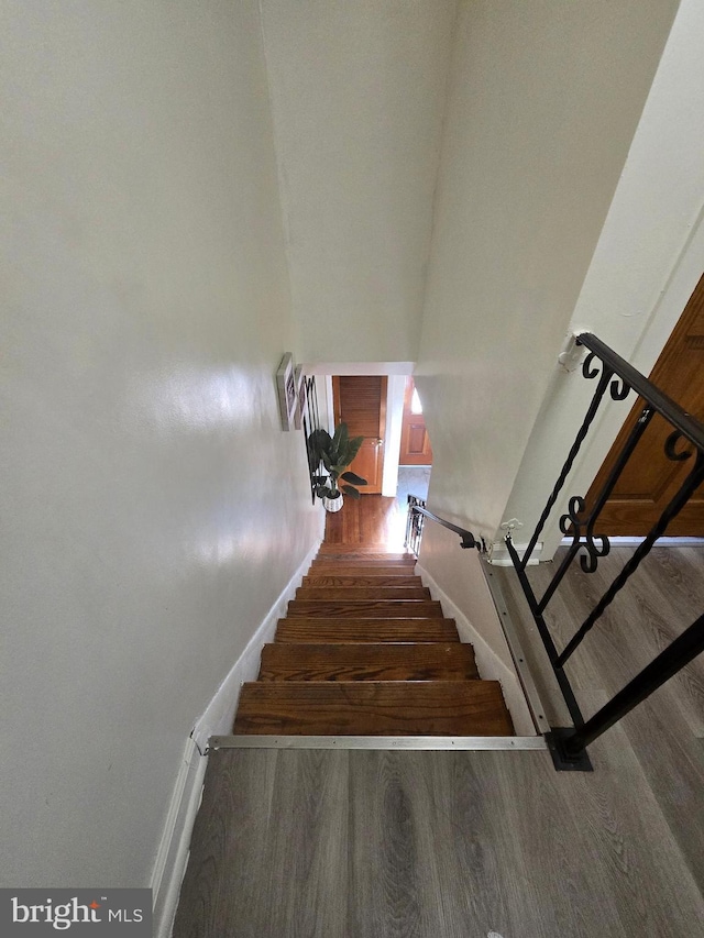 stairs with baseboards and wood finished floors