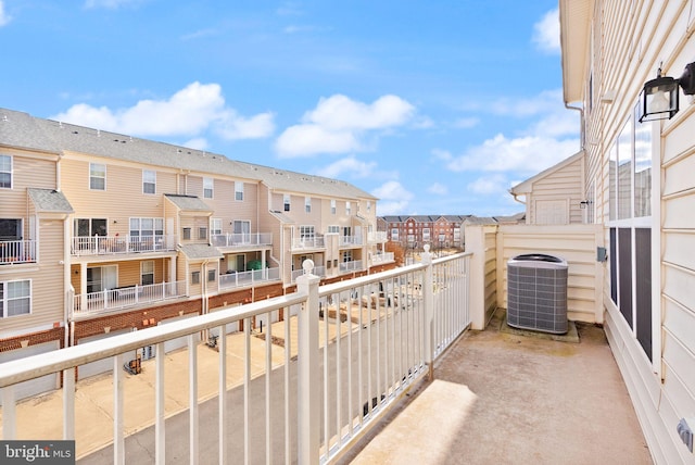 balcony featuring a residential view and central air condition unit