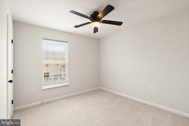 unfurnished room with light carpet, ceiling fan, and baseboards