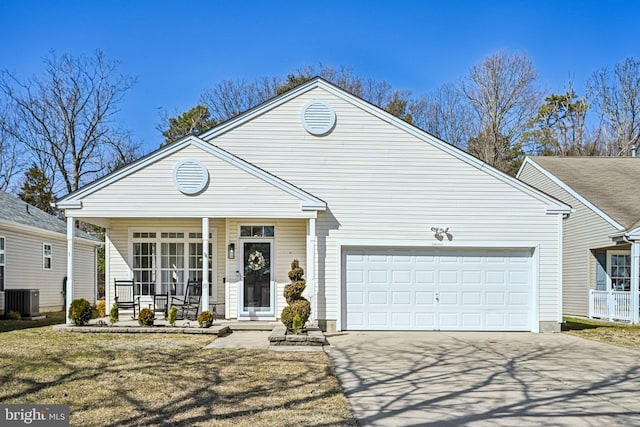 view of front of house featuring central air condition unit, an attached garage, a porch, and concrete driveway