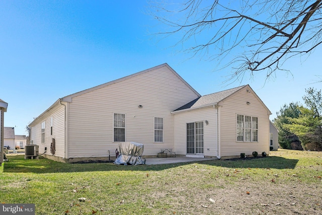 back of house featuring a patio area, a lawn, and central AC unit