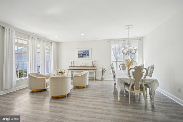 dining room featuring a chandelier, recessed lighting, baseboards, and wood finished floors